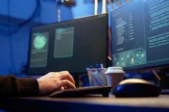 ethical hacker working in cybersecurity in front of computers