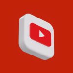 a red and white play button on a red background