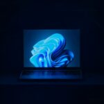 a macbook air laptop in a dark room
