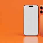 Two orange smartphones on an orange background.