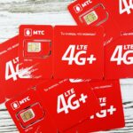 a group of red sim cards sitting on top of a wooden table
