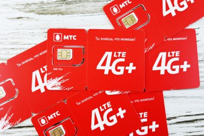 a group of red sim cards sitting on top of a wooden table
