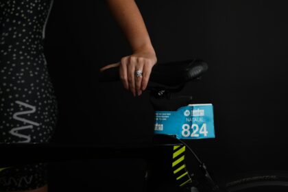 person holding black and green box
