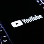 The youtube logo on a smartphone is visible.