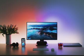 black flat screen computer monitor on brown wooden desk