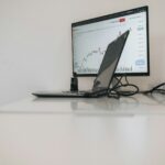 a desk with a laptop and a monitor on it