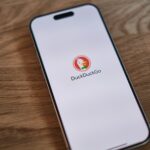 A cell phone sitting on top of a wooden table