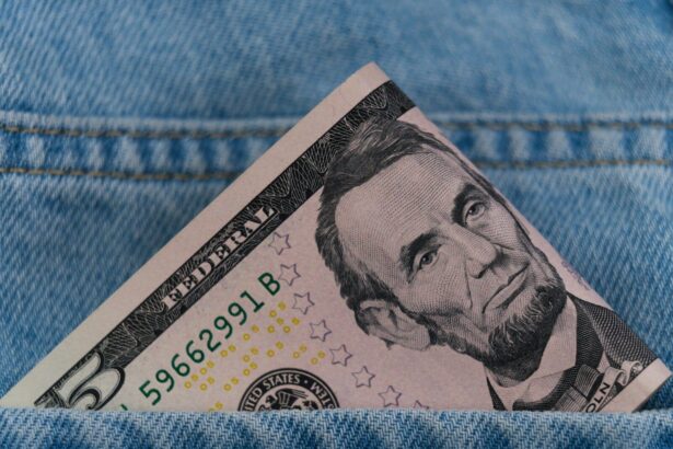 a dollar bill sticking out of the back pocket of a pair of jeans