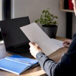 Office desk with invoice and laptop keyboard