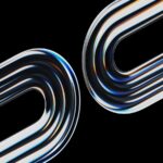 Two curved metallic objects reflect light on black