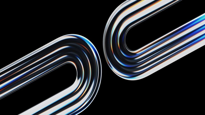 Two curved metallic objects reflect light on black