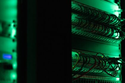 a rack of electronic equipment in a dark room