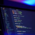 laptop screen displaying colorful code